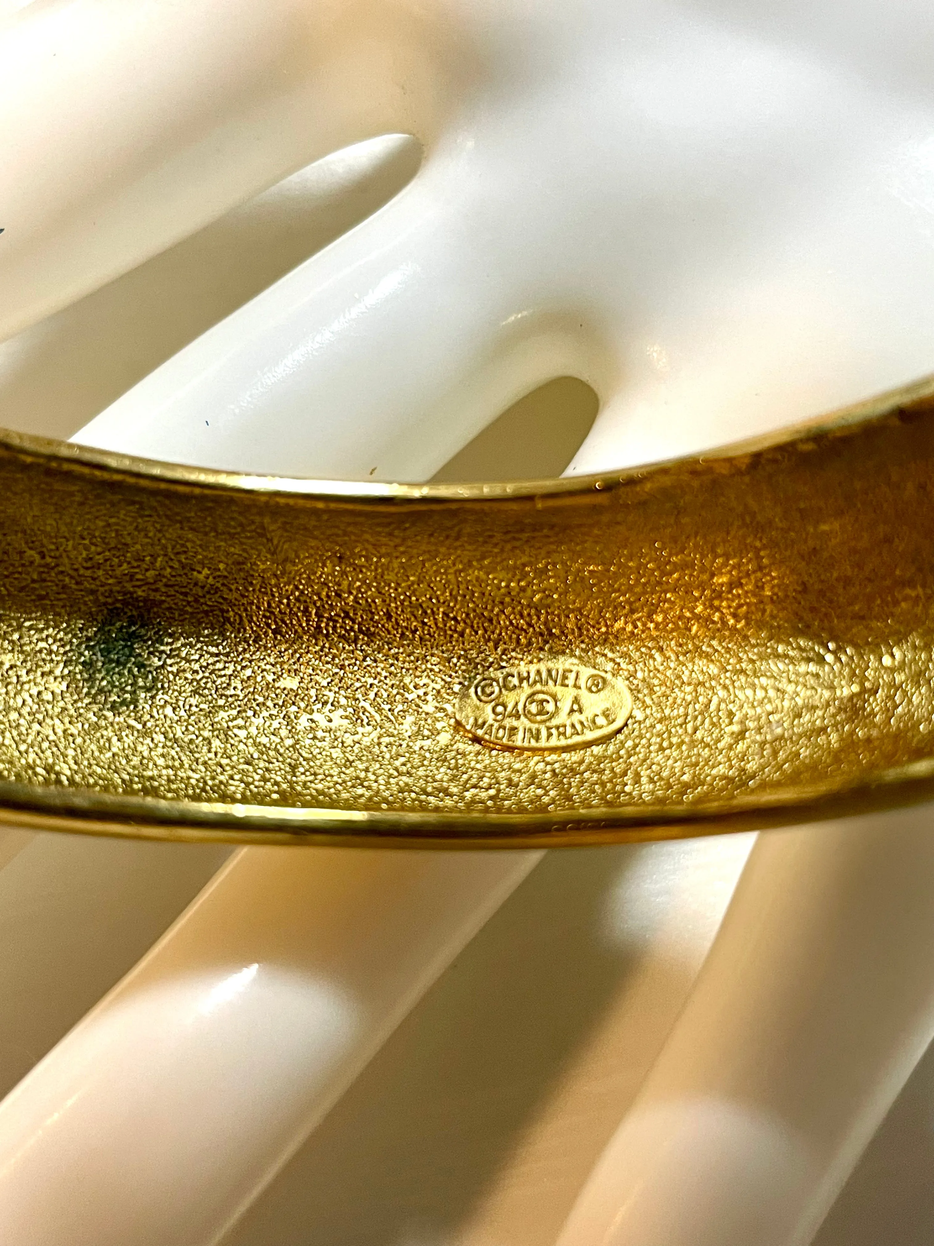 Vintage Chanel golden bangle with embossed black logo.  Must have gorgeous jewelry. 060810r1