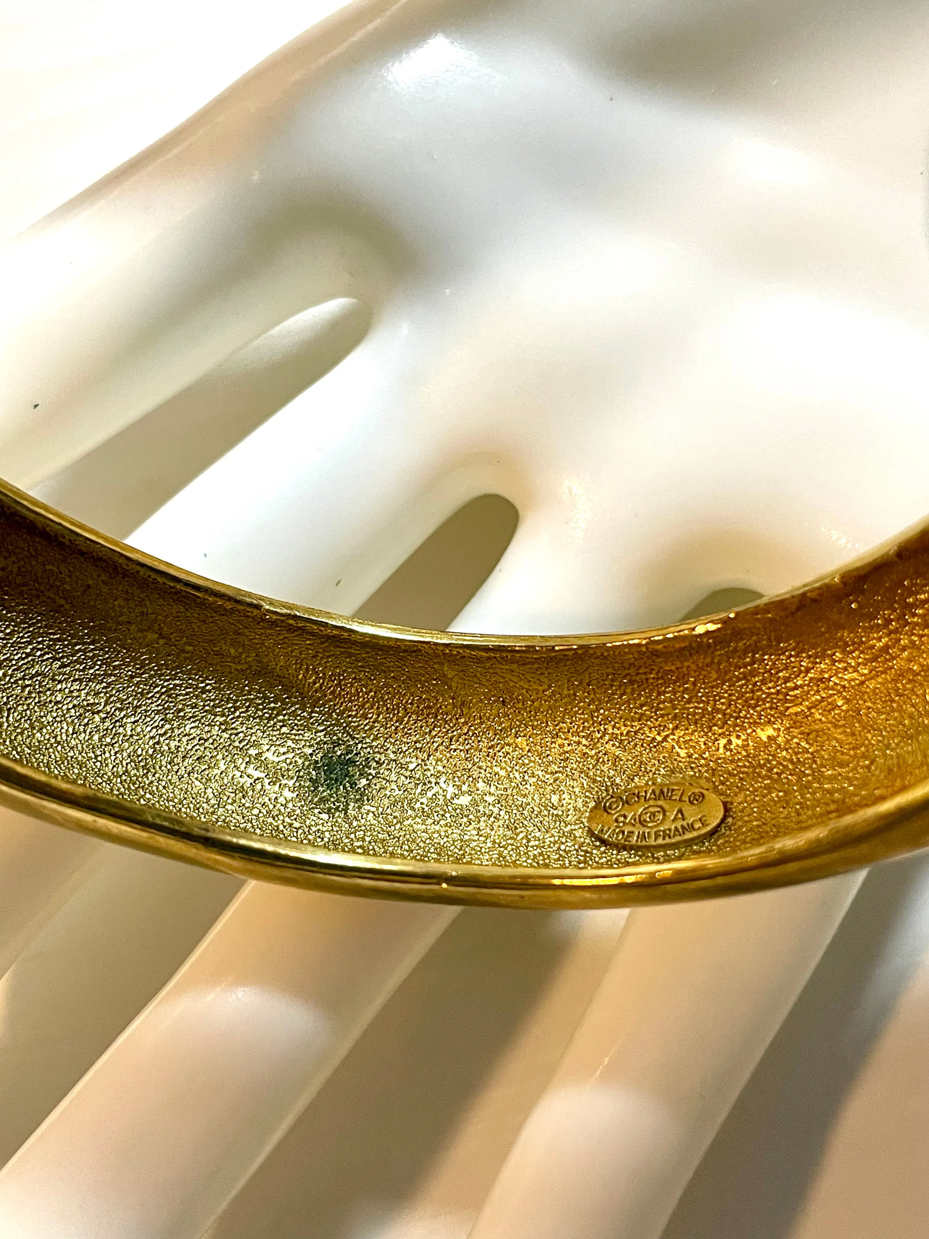 Vintage Chanel golden bangle with embossed black logo.  Must have gorgeous jewelry. 060810r1