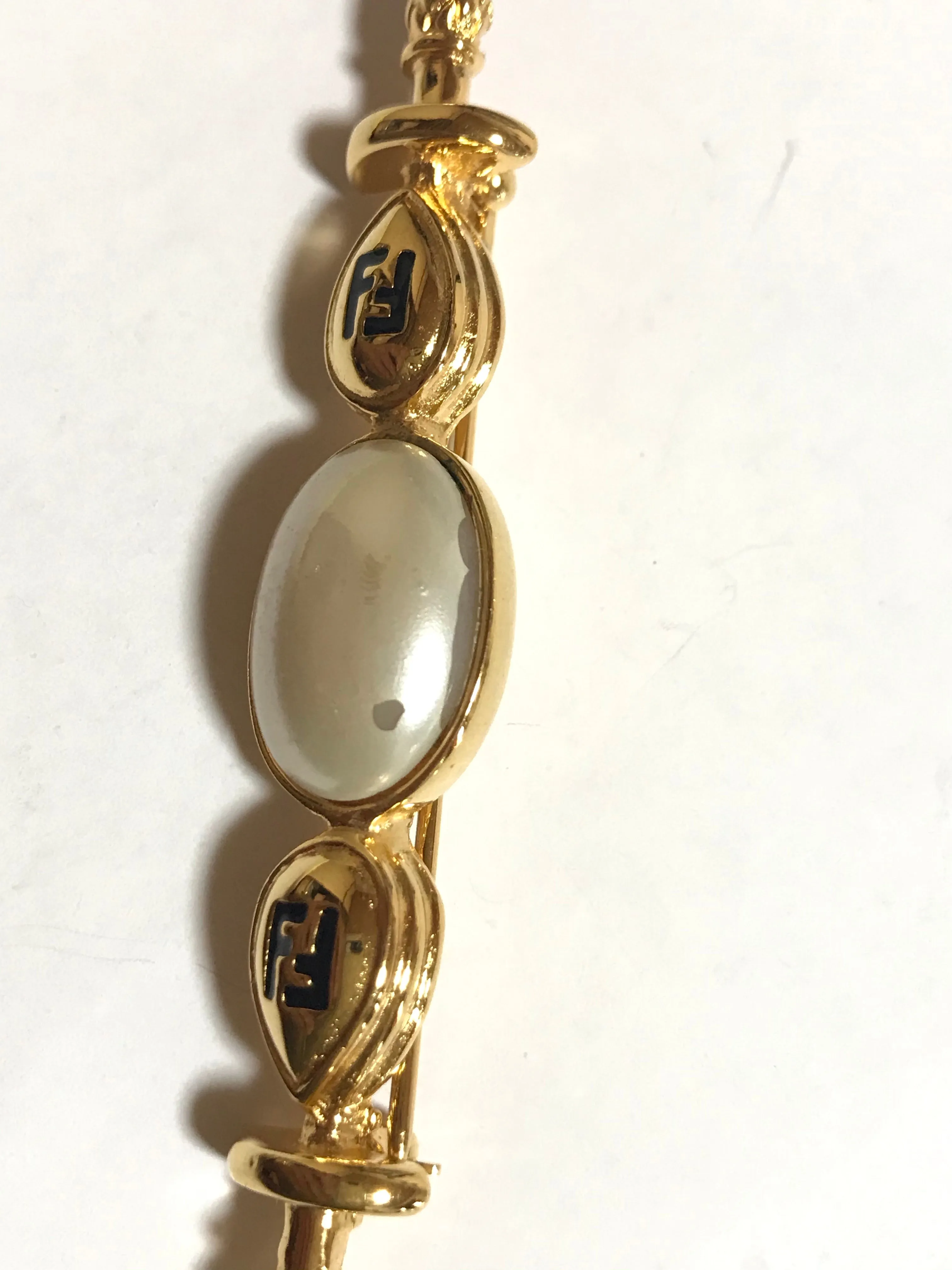 Vintage FENDI gold tone hat pin with white oval faux pearl and FF mark. Can be used as a brooch pin, jacket brooch pin too. 060926re5