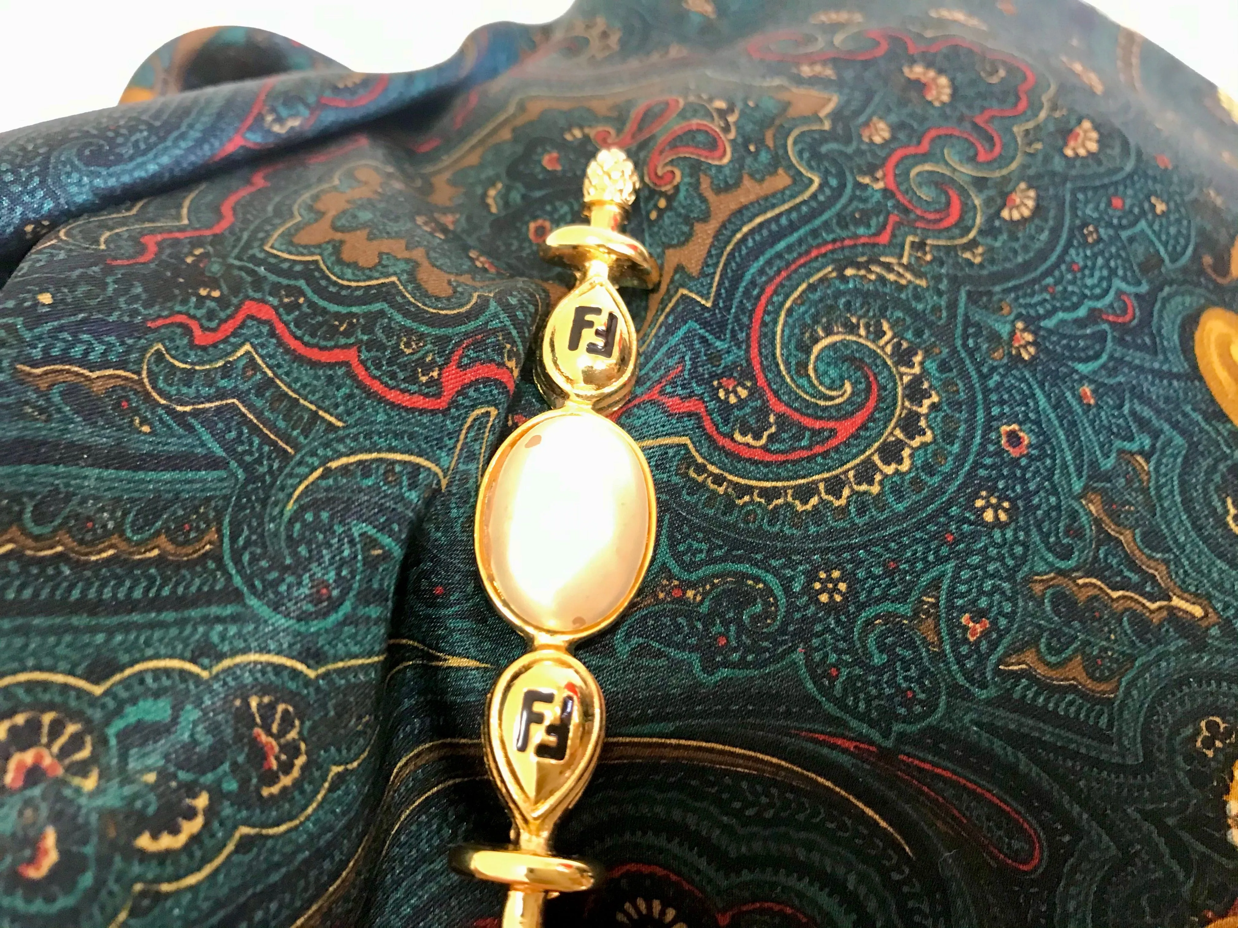 Vintage FENDI gold tone hat pin with white oval faux pearl and FF mark. Can be used as a brooch pin, jacket brooch pin too. 060926re5