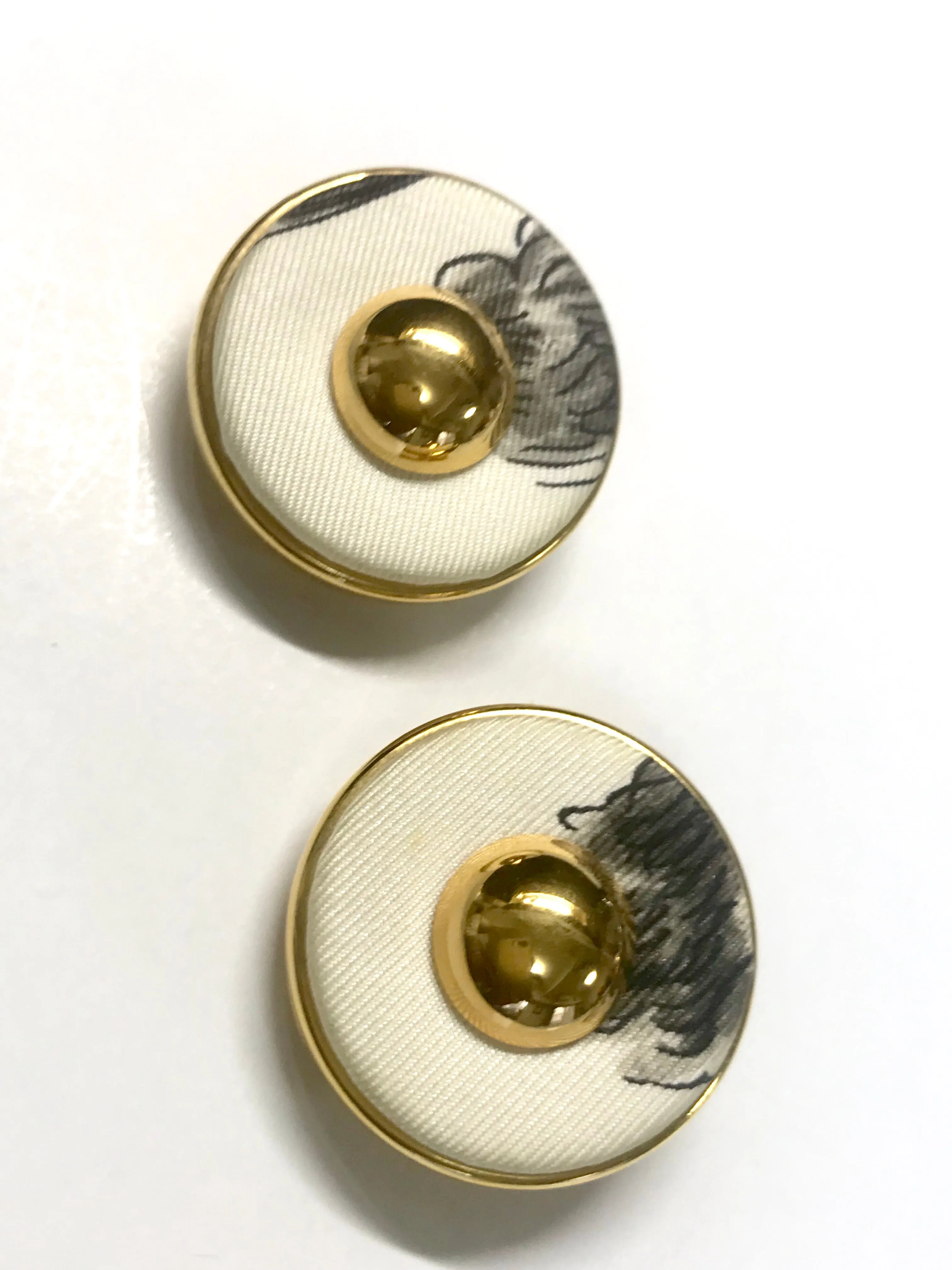 Vintage HERMES golden round earrings with white silk fabric frames. Classic jewel piece.