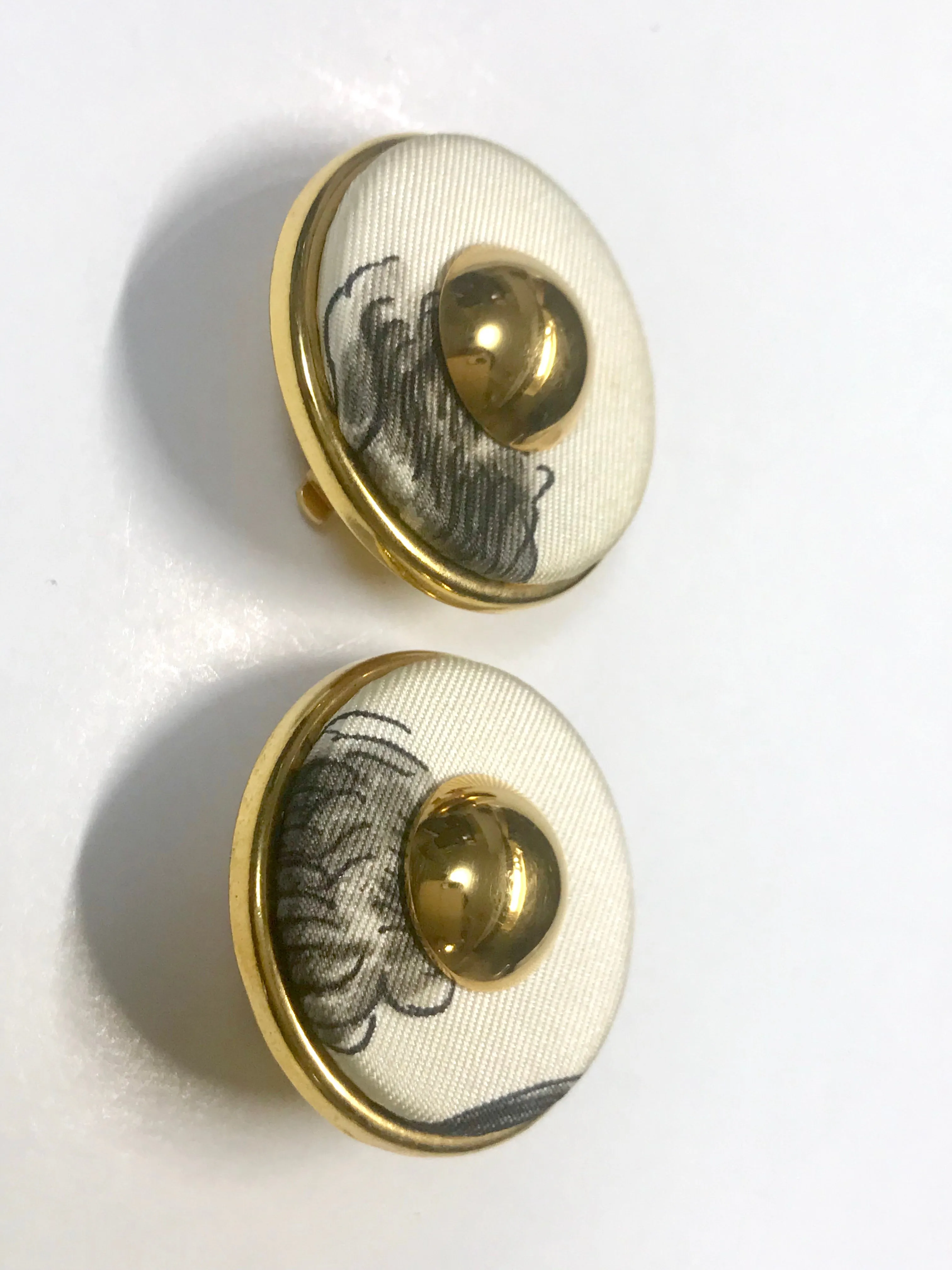 Vintage HERMES golden round earrings with white silk fabric frames. Classic jewel piece.